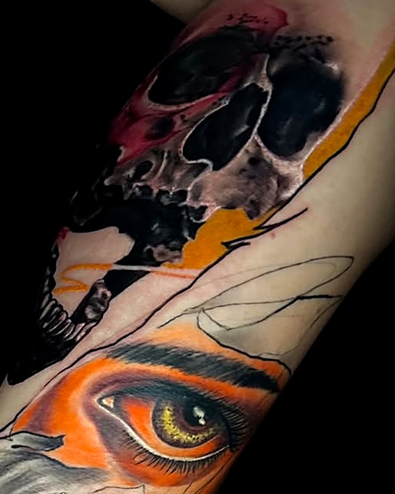 Bold custom tattoo — skull and eye piece by HateLove Tattoo Studio