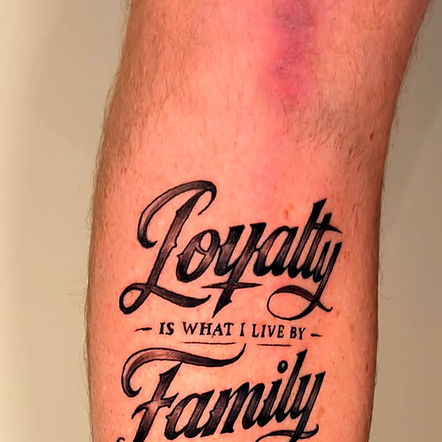 Custom script lettering tattoo reading Loyalty is what I live by, Family