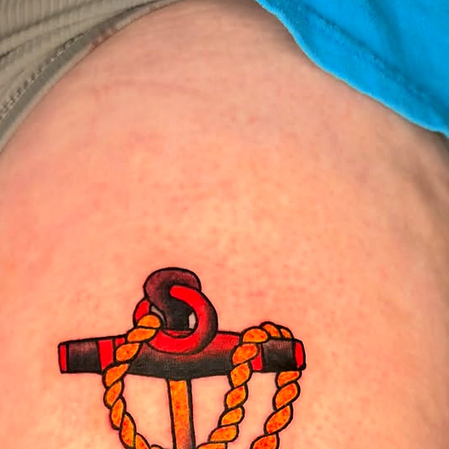 Traditional Sailor Jerry style anchor tattoo with rope in red, black and orange